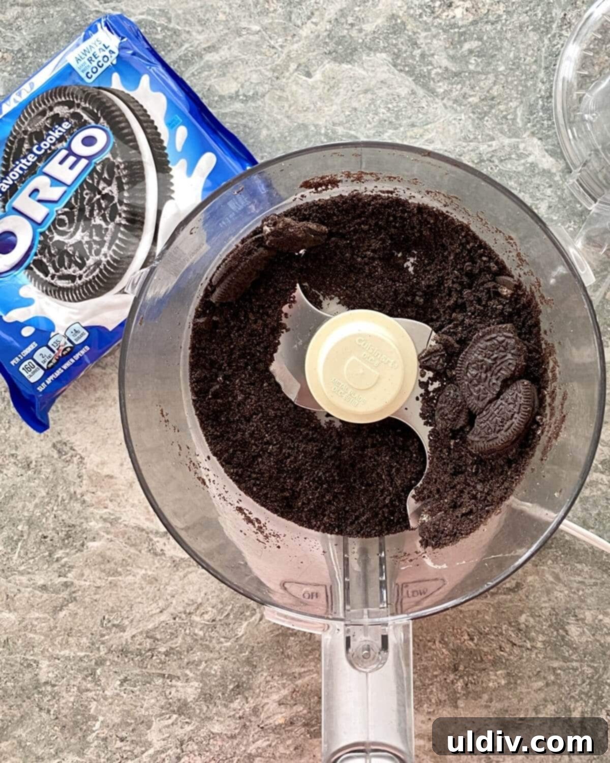 Quick and Easy Oreo Cheesecake 4 Crushed Oreo cookies in a food processor, ready to be mixed with butter for the crust.