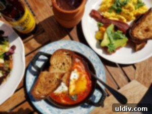Etta A Taste of Hearth Magic 16 The finished fire-roasted eggs, served hot in a cast iron pan with a side of toasted sourdough bread.