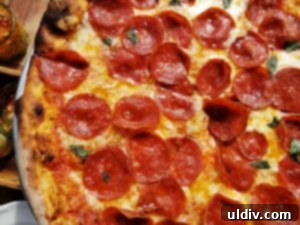 Etta A Taste of Hearth Magic 20 A perfectly cooked pepperoni pizza with a crispy crust, fresh from etta's hearth oven.
