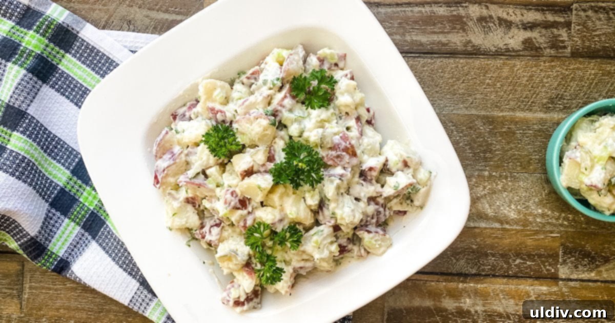 bowl of creamy potato salad with dill pickles