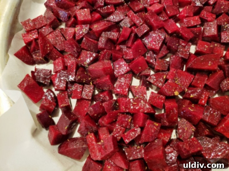 Super Bowl Vegan Snacks: Beetroot Appetizer & Plant-Based Game Day Recipes 5 Beetroot cubes seasoned and spread on a baking sheet, ready to be roasted.