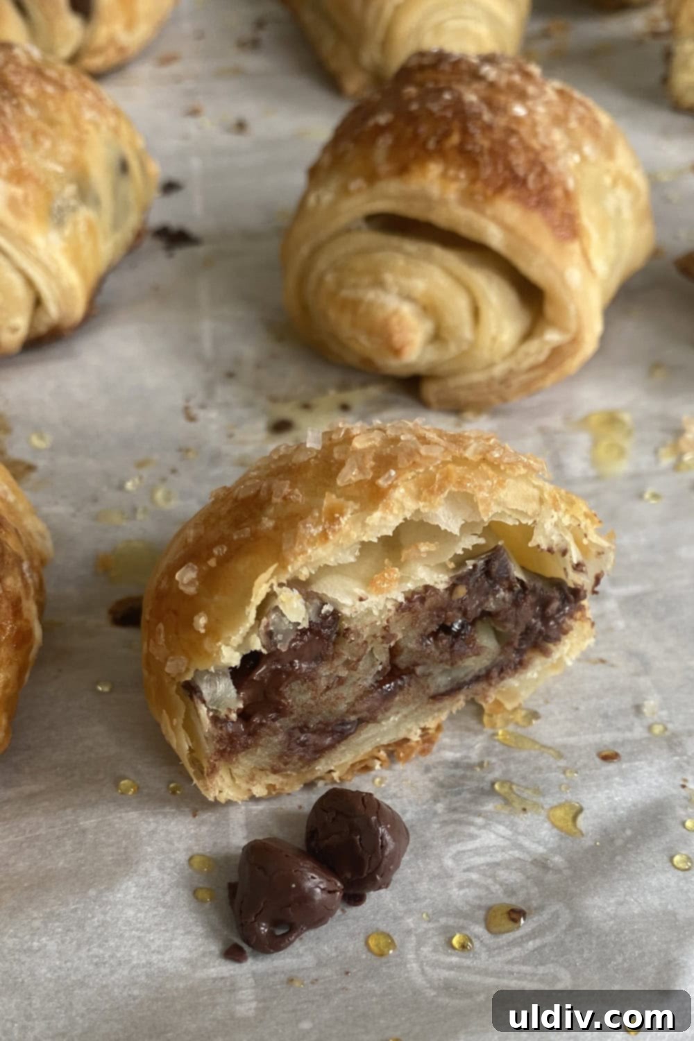 Flaky Chocolate Puff Bites 8 a cross-section of a chocolate puff pastry roll, revealing the flaky layers and melted chocolate filling