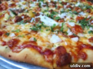 A delectable deep-dish pizza from Gino's East, showcasing its thick crust and rich toppings.