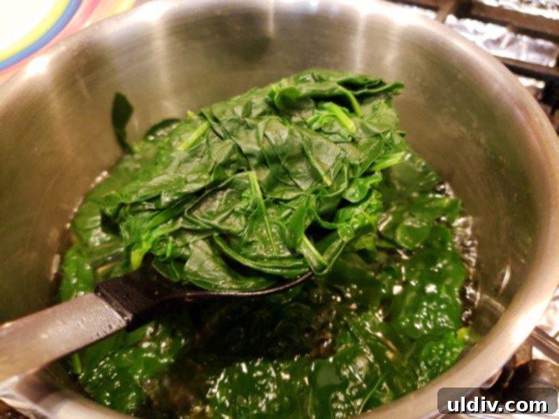 Fresh Greens For Spring Fuel Your Vibrant Life 4 Cooling wilted spinach on a wooden cutting board
