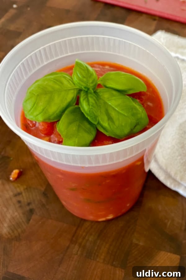 Garden-Fresh Basil Marinara 5 Freshly made homemade marinara sauce stored in a clear container, ready for refrigeration or freezing