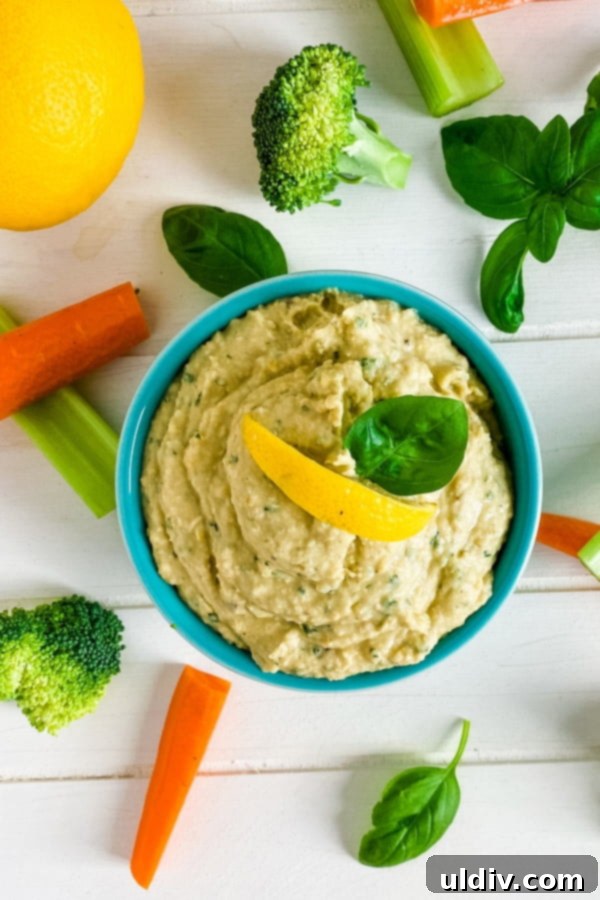 Emerald Basil Hummus 2 bowl of hummus with cut up veggies