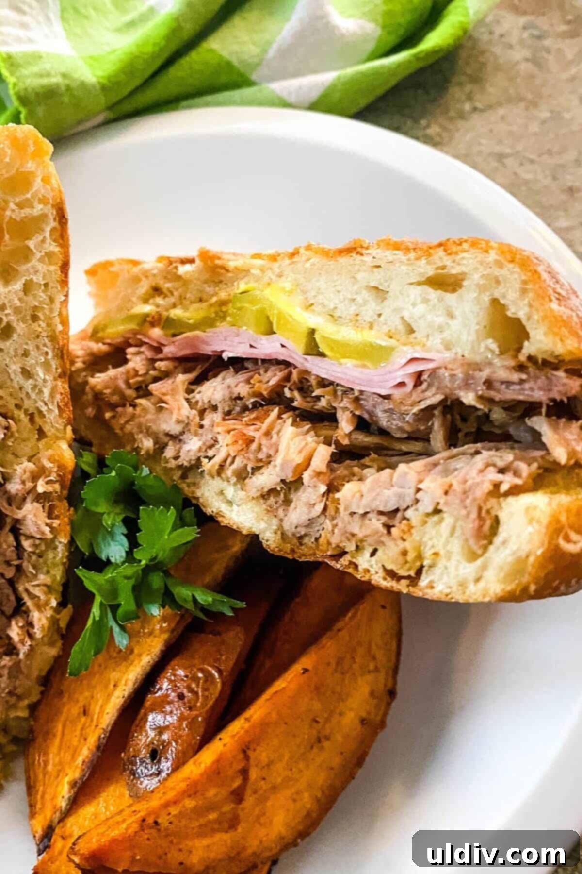 Instant Pot Cuban Pork Sandwiches 5 A delicious Cuban sandwich served alongside a side of roasted sweet potato wedges, offering a complete and satisfying meal.