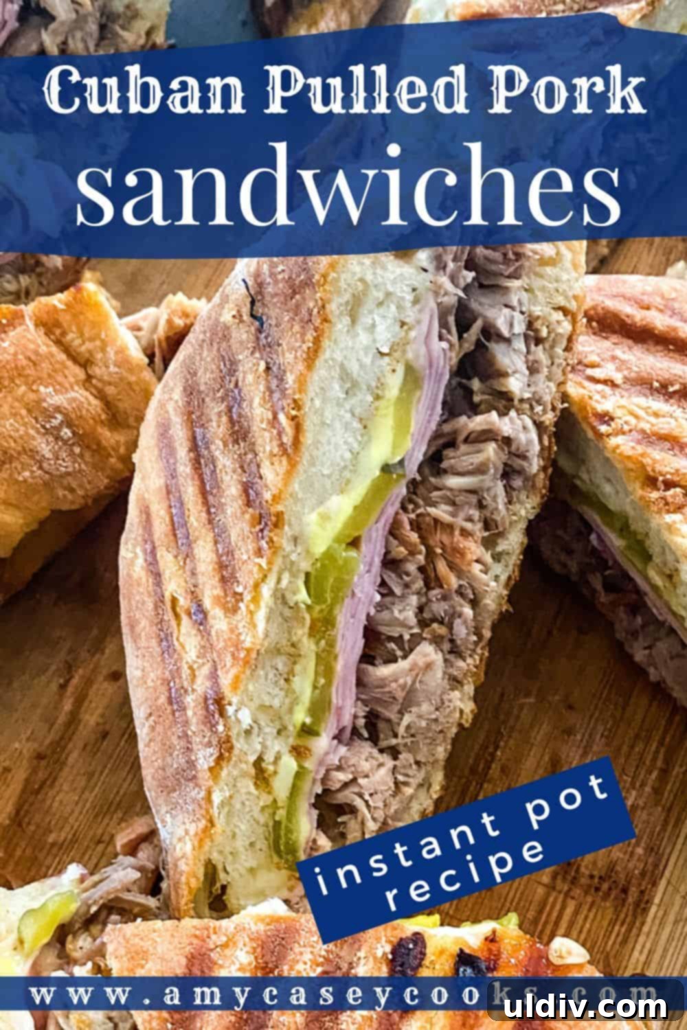 Instant Pot Cuban Pork Sandwiches 6 A close-up view of a perfectly pressed Cuban sandwich, showcasing the layers of juicy pulled pork, ham, and melted cheese, with dill pickles peeking out.