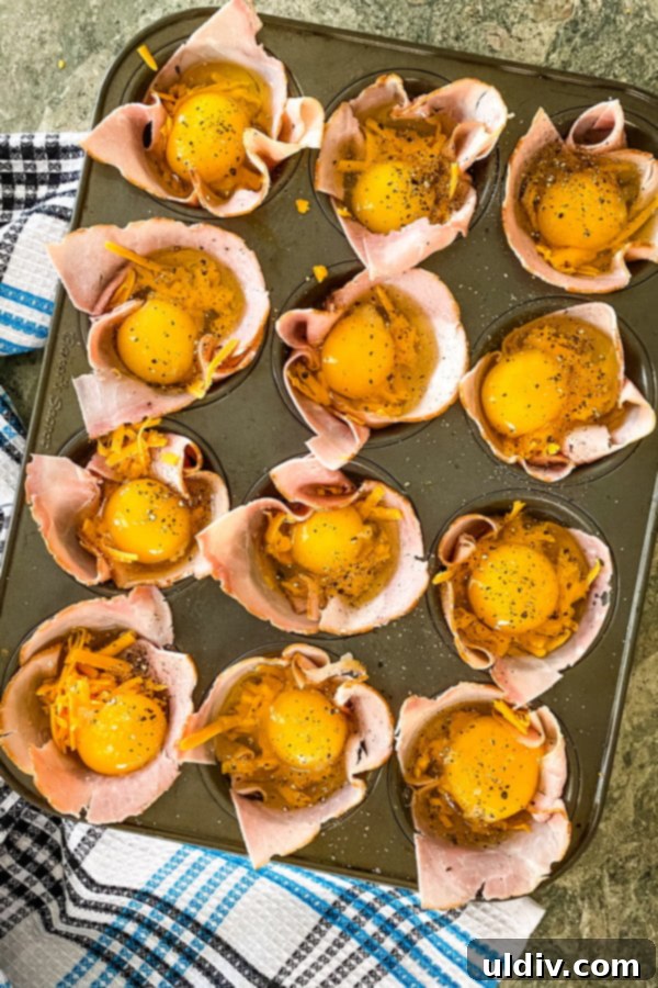 Effortless Ham & Egg Breakfast Bites 4 Ham and egg cups ready to go in the oven