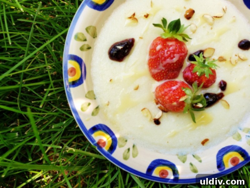 Semolina Pudding A Sweet Childhood Memory 2 Warm semolina pudding topped with fresh berries, nuts, and a drizzle of sauce, offering a comforting and delicious dessert experience.
