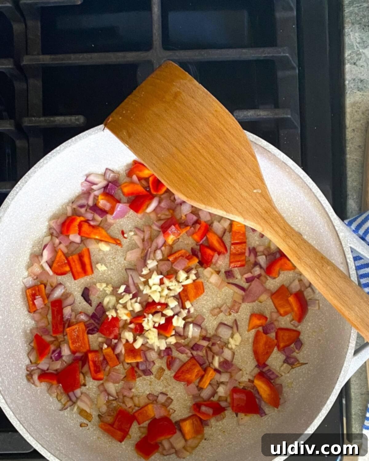 Onion, red pepper and garlic in a pot to sauté.