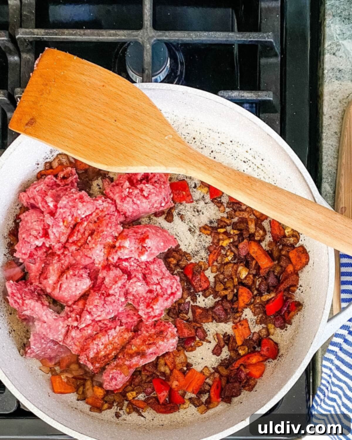 Ground beef added to the pot to brown.