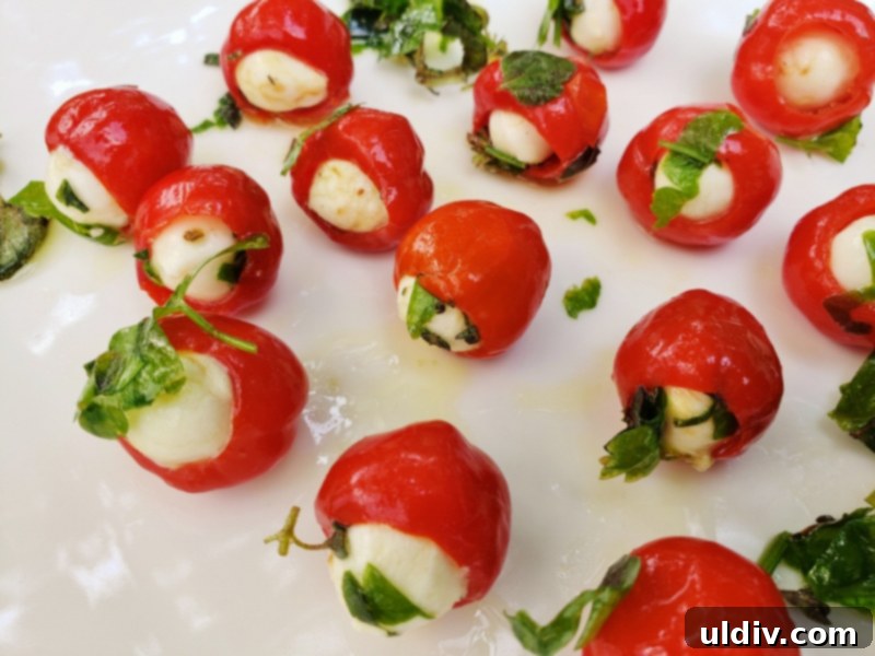 Herb-Packed Peppadew & Mozzarella 4th of July Appetizer 4 Hand gently stuffing a Peppadew pepper with a mozzarella pearl