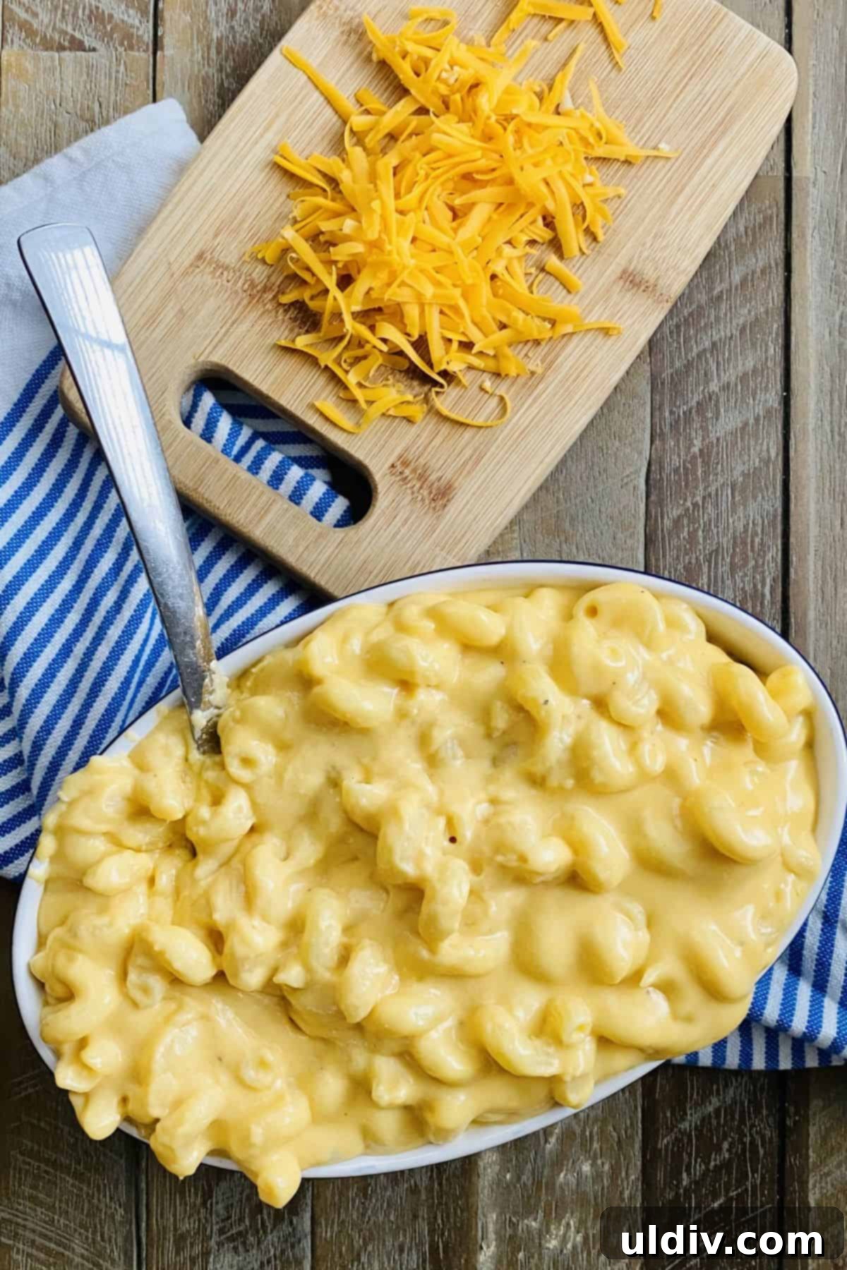 Foolproof Gooey Mac and Cheese 5 Grated sharp cheddar cheese and a serving bowl filled with easy mac and cheese.