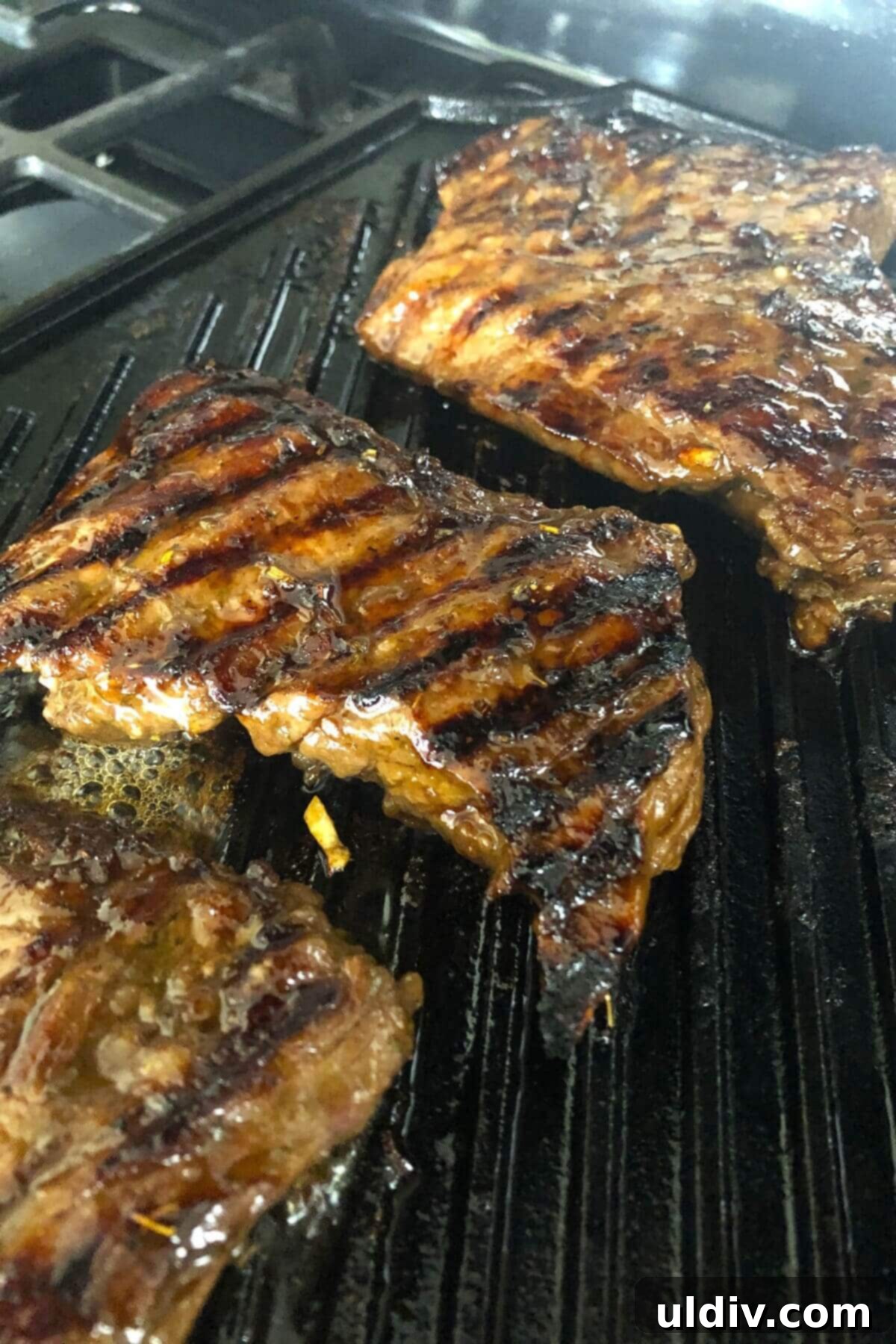 Blue Cheese Steak Salad with Balsamic Herbs 11 Grilling skirt steaks on a grill pan, showing the ideal method for achieving a perfect char and tender interior.