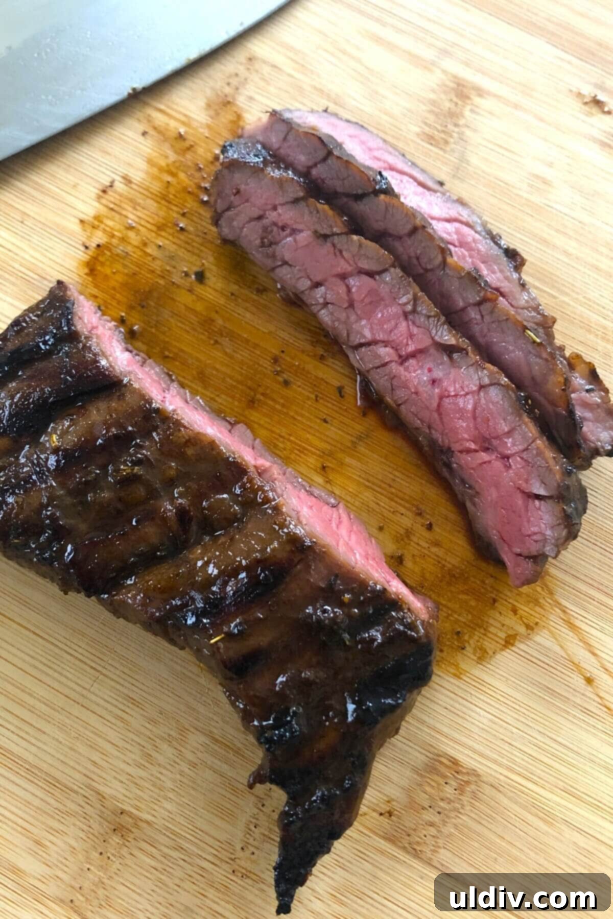 Blue Cheese Steak Salad with Balsamic Herbs 12 Sliced skirt steak on a cutting board, demonstrating the tender, thin cuts achieved by slicing against the grain.