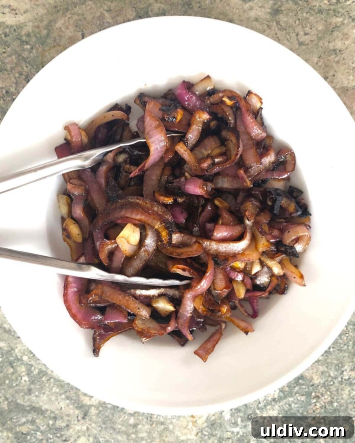 Balsamic Herb Grilled Steak Salad with Crumbled Blue Cheese 6 Sweet and savory roasted red onions, beautifully caramelized, sit in a bowl after baking.