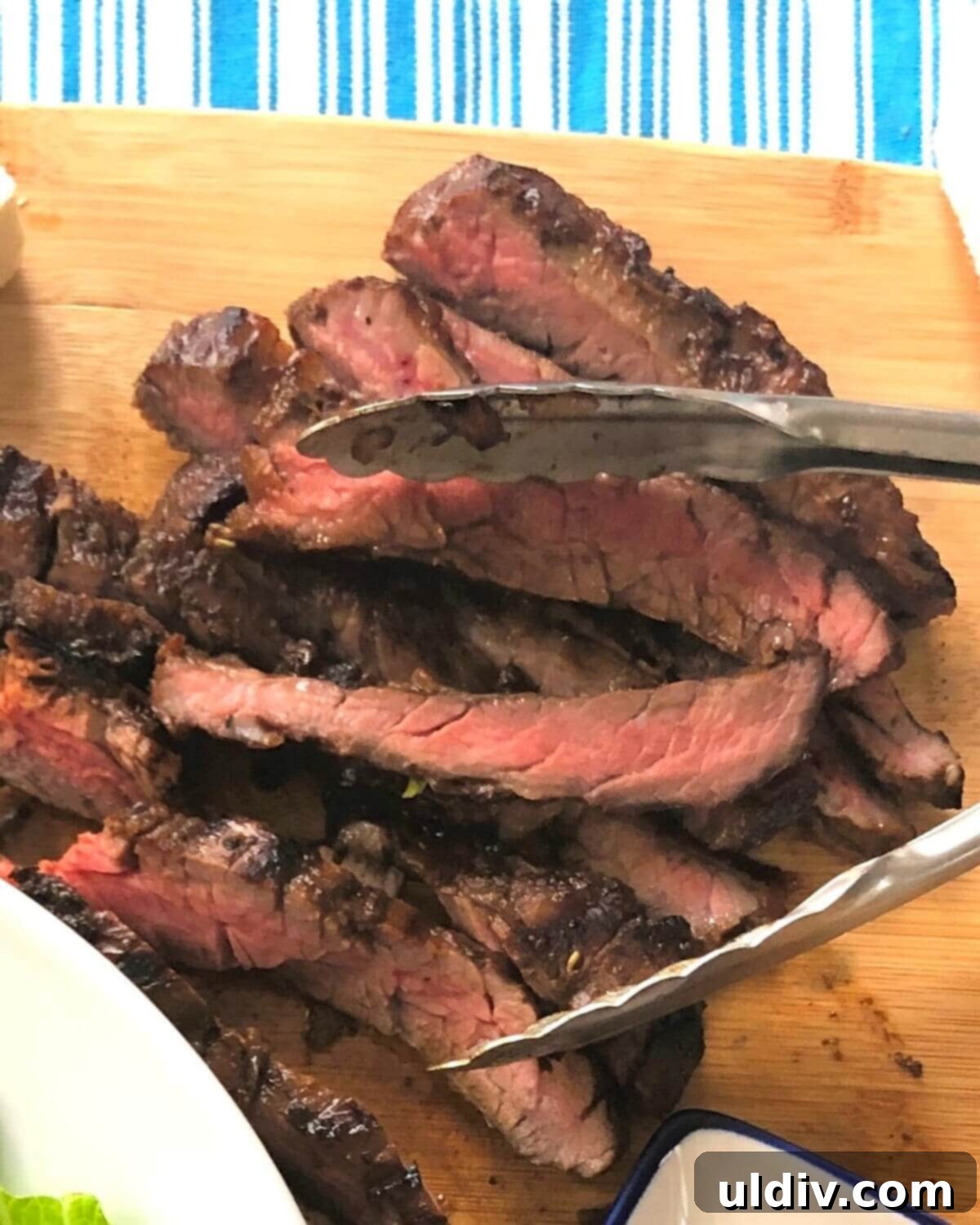 Balsamic Herb Grilled Steak Salad with Crumbled Blue Cheese 9 Perfectly grilled and rested skirt steak being sliced against the grain into thin, tender strips.