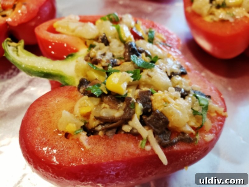 Cauliflower Mushroom Stuffed Peppers: Our Plant-Based Evolution 8 Stuffed bell pepper halves arranged on an oiled baking pan, ready for the oven