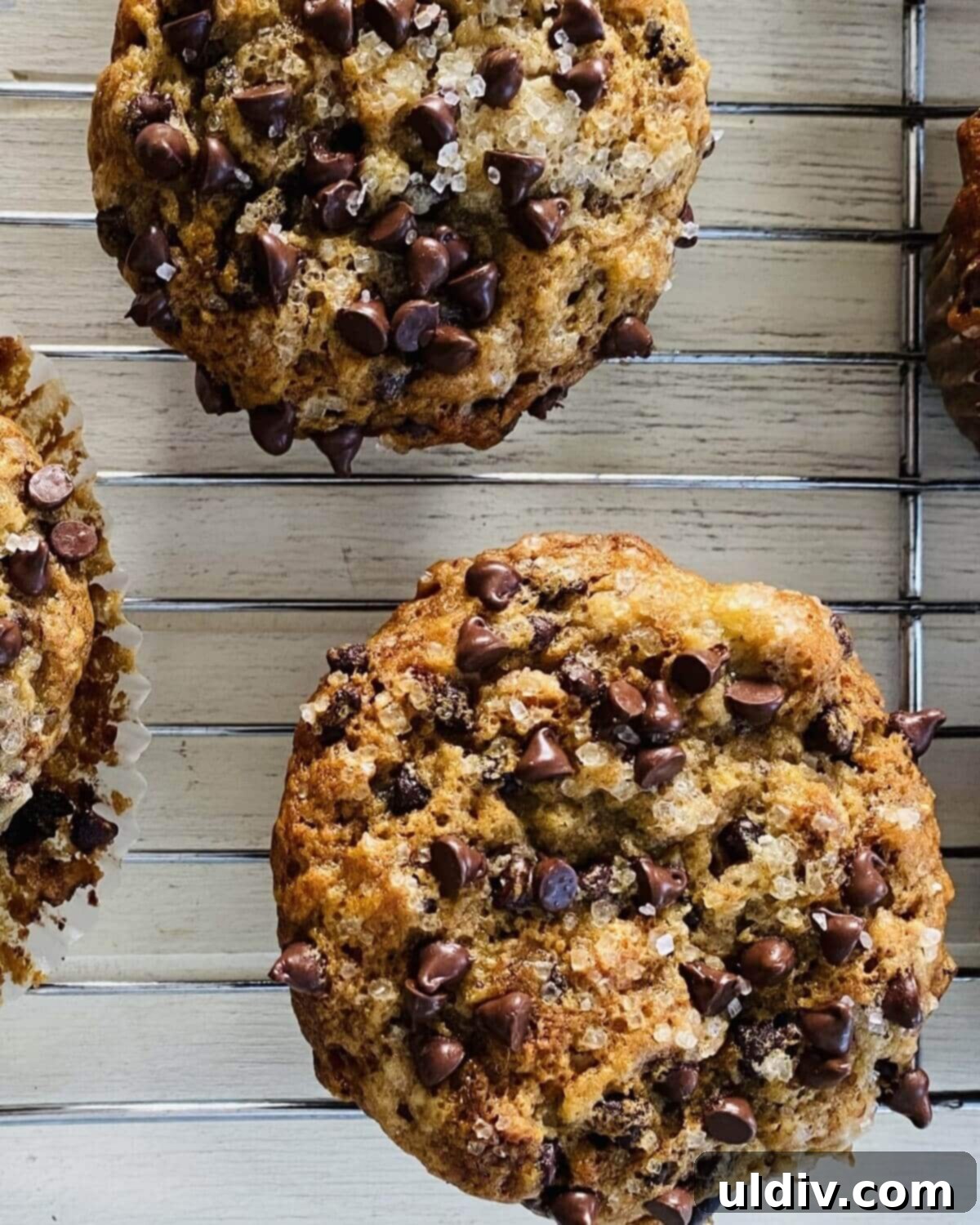Naturally Sweet Vegan Banana Muffins 13 Two freshly baked dairy-free banana muffins resting on a wire cooling rack.