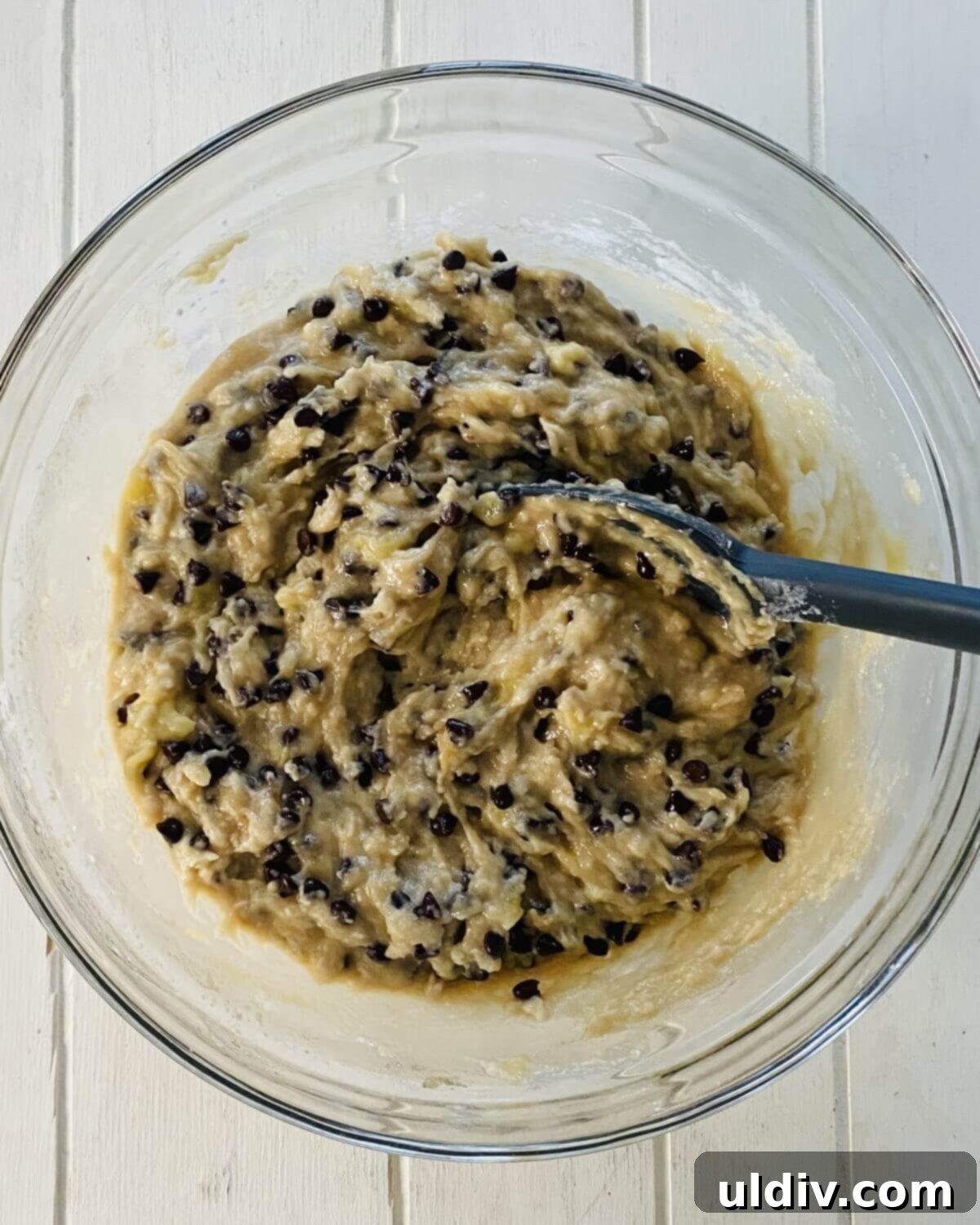 Irresistible Vegan Banana Muffins 9 Lumpy dairy-free banana muffin batter in a mixing bowl, illustrating the ideal consistency before baking.