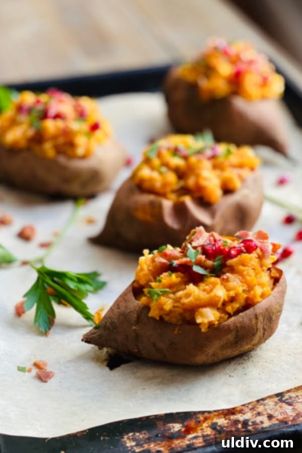Loaded Sweet Potatoes: Apple, Bacon & Pomegranate 6 Four beautifully presented apple and bacon stuffed sweet potatoes, topped with fresh pomegranate and parsley, ready to be enjoyed.