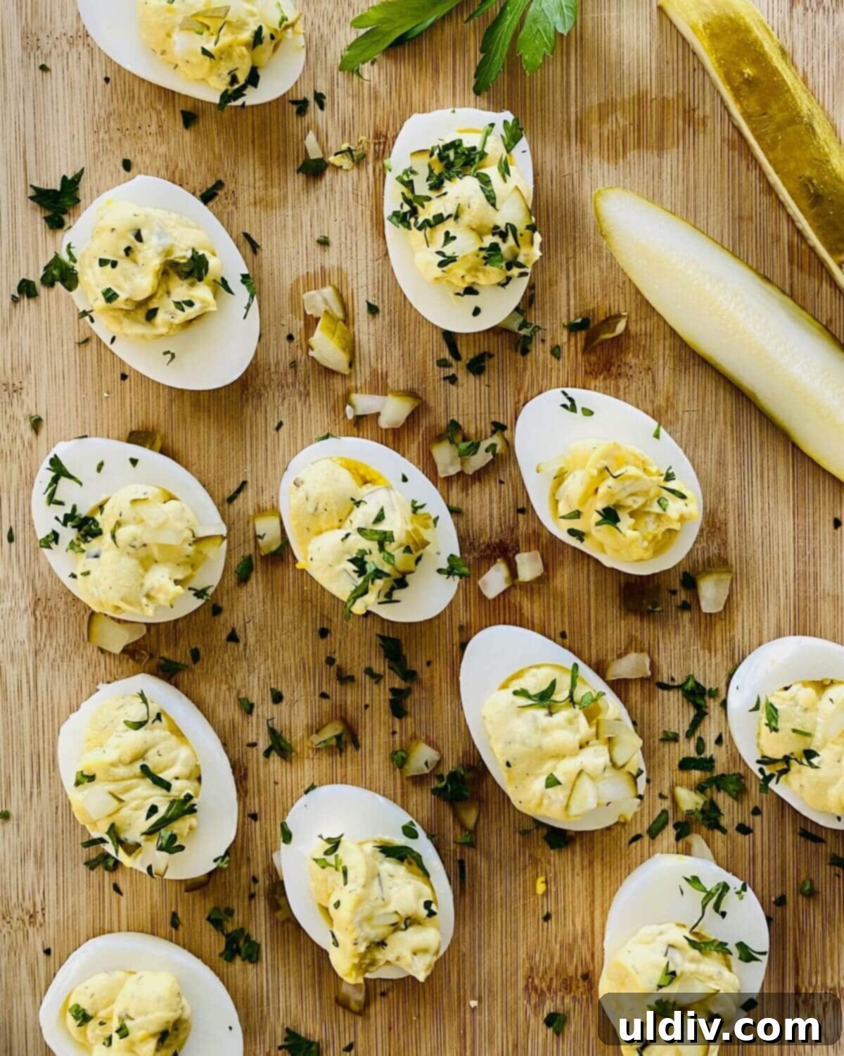 Zingy Dill Pickle Deviled Eggs 11 dill pickle stuffed hard boiled eggs on a cutting boad.