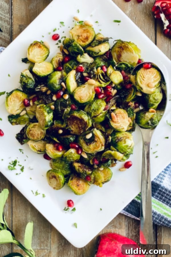 Honey Mustard Glazed Brussels Sprouts 2 plate of roasted Brussels sprouts with pine nuts and pomegranate arils