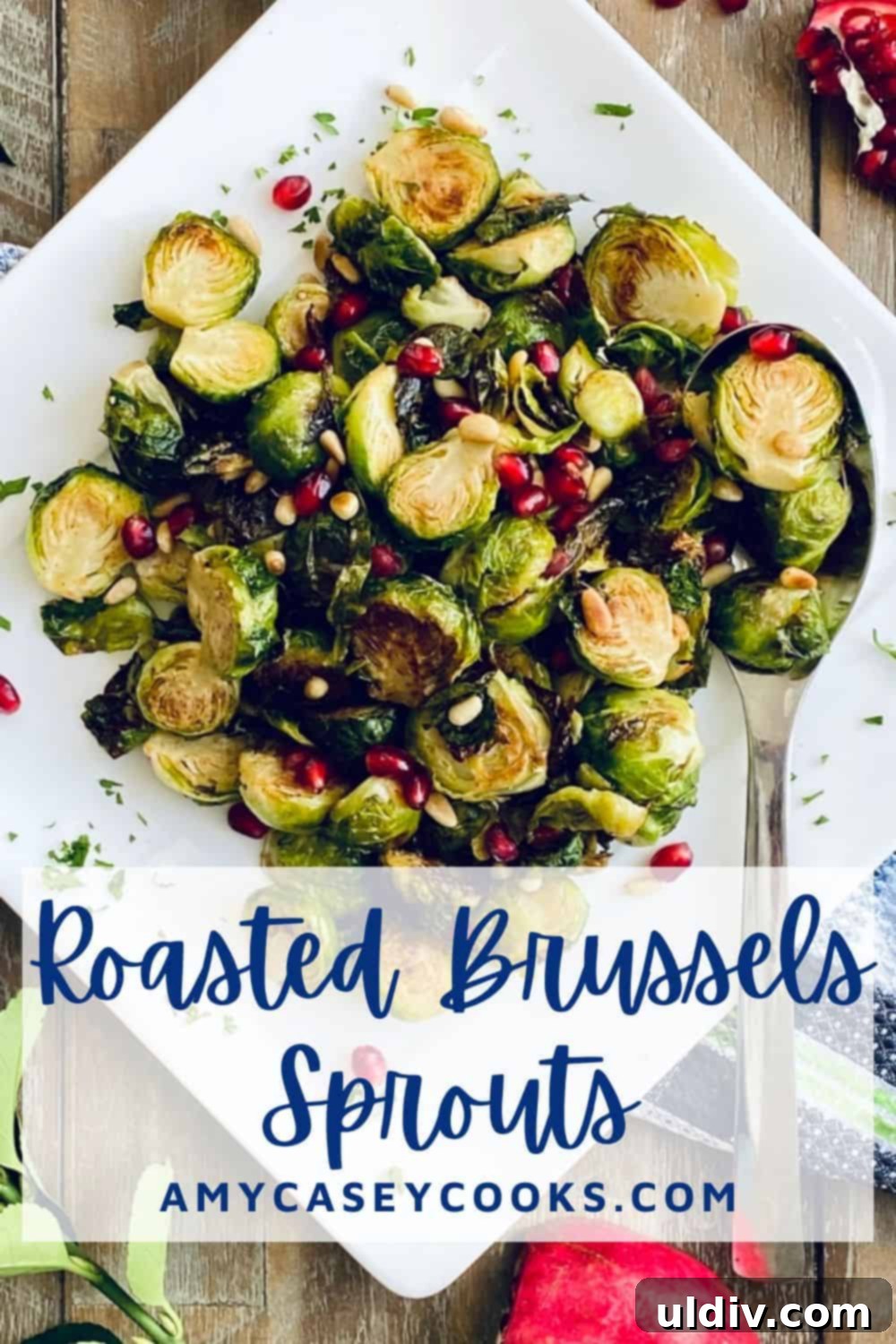 Caramelized Honey Mustard Brussels Sprouts 6 white plate with honey roasted brussels sprouts, garnished with pine nuts and pomegranate