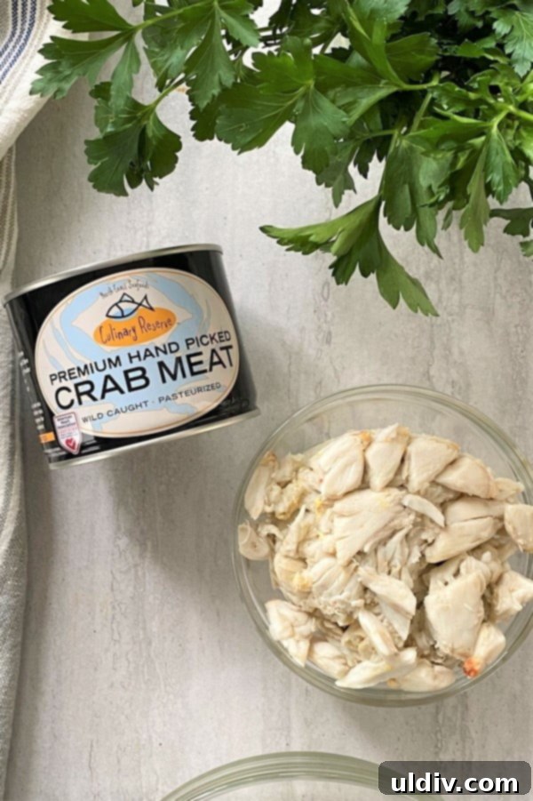 Crab BLT Sliders 3 can of crab meat and a bowl of crab meat.
