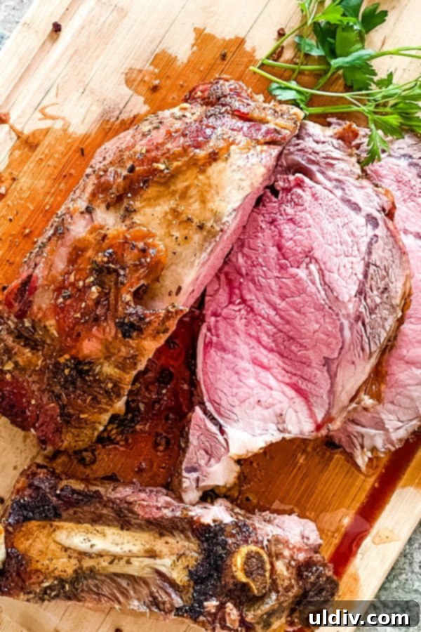Melt-in-Your-Mouth Slow-Roasted Prime Rib 2 Perfectly sliced slow roasted prime rib on a cutting board, showcasing its juicy, pink interior and golden-brown crust.