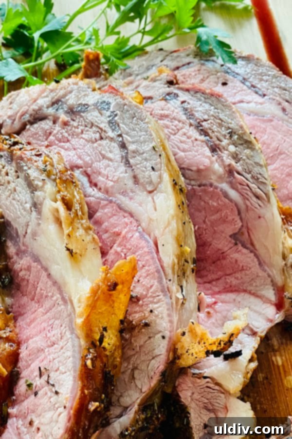 Melt-in-Your-Mouth Slow-Roasted Prime Rib 4 A close-up view of perfectly sliced slow roasted prime rib, revealing its tender texture and rich, savory juices, ready for serving.