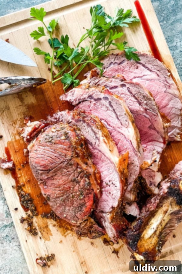 Melt-in-Your-Mouth Slow-Roasted Prime Rib 6 A cutting board displays freshly sliced slow roasted prime rib, highlighting its succulent texture and readiness to be served.