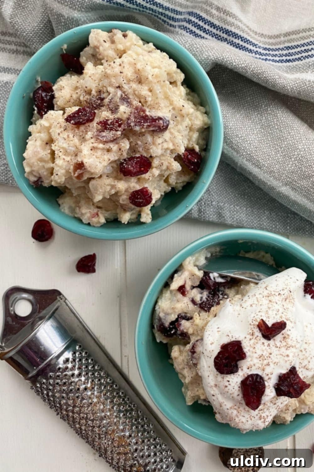 Classic Creamy Stovetop Rice Pudding 2 Two inviting bowls of creamy stovetop rice pudding, one elegantly topped with fluffy whipped cream and a sprinkle of cinnamon, showcasing the comforting dessert.