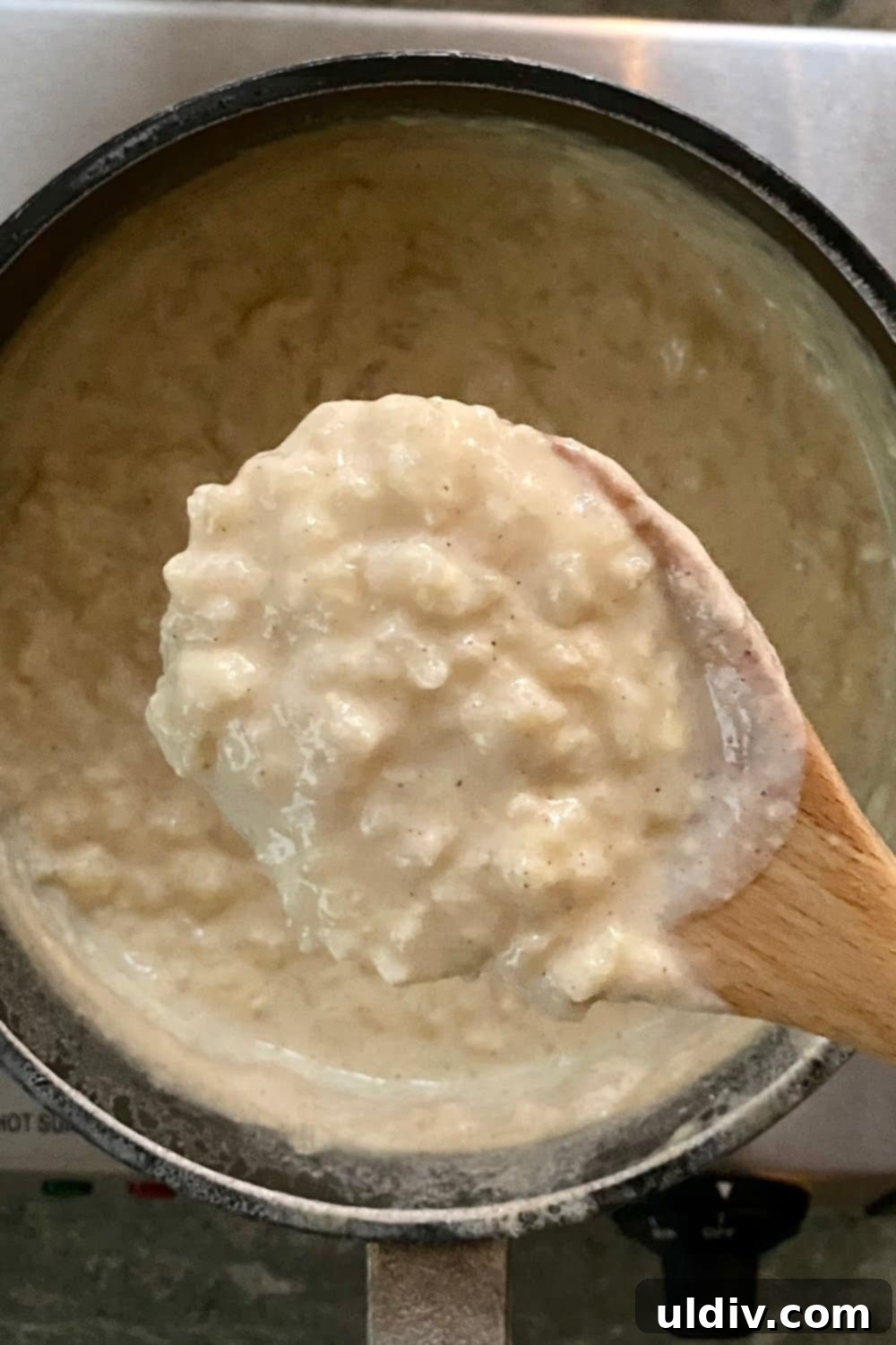 Grandma's Stovetop Rice Pudding 5 A pot of creamy rice pudding simmering gently on the stovetop, demonstrating the easy, hands-on cooking process that yields a comforting homemade dessert.