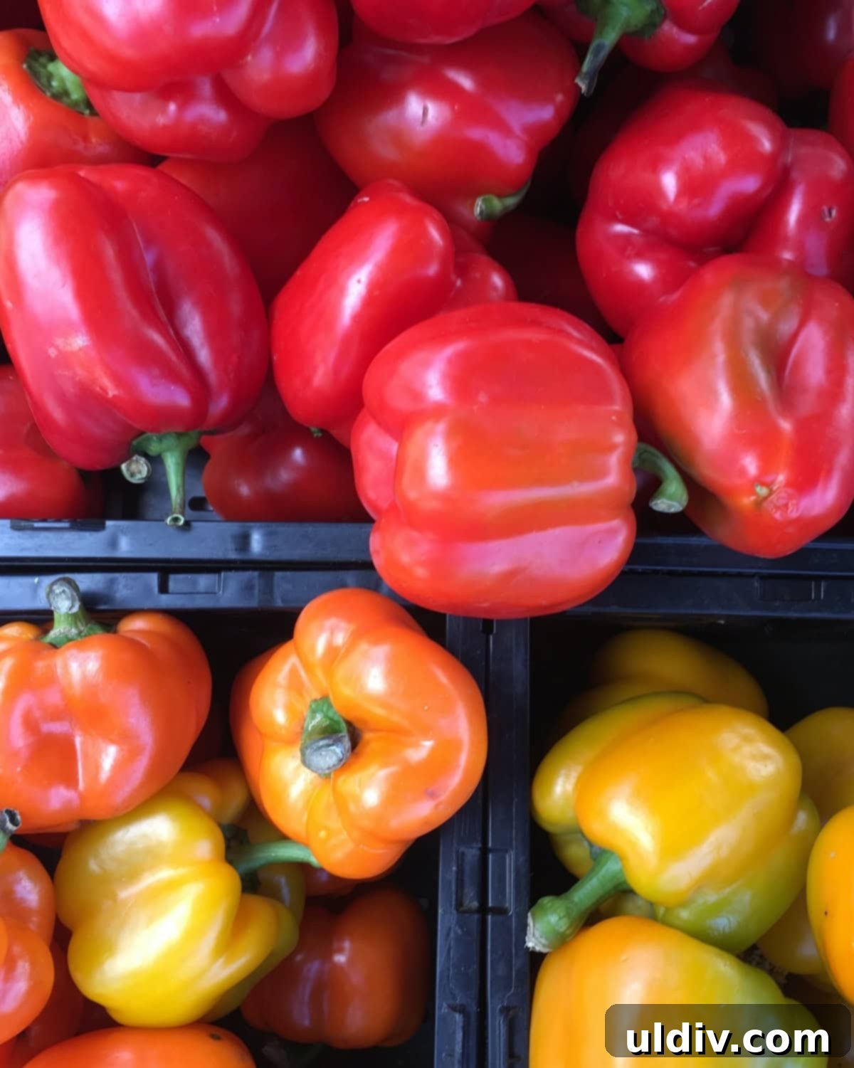 30-Minute Summer Garden Bean Chili 3 A vibrant display of red, yellow, and orange bell peppers, ready for cooking.