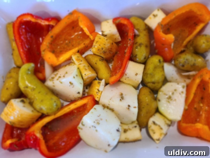 Feasting on Turkey and Duck: A Maple Leaf Farms Review 4 Assortment of root vegetables coated in rich duck fat, seasoned with herbs, ready for roasting in a pan