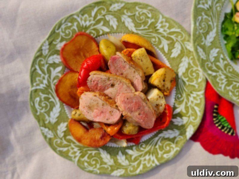 Feasting on Turkey and Duck: A Maple Leaf Farms Review 7 Plated duck breast with crispy skin, alongside roasted quince, apples, and root vegetables, garnished with fresh herbs