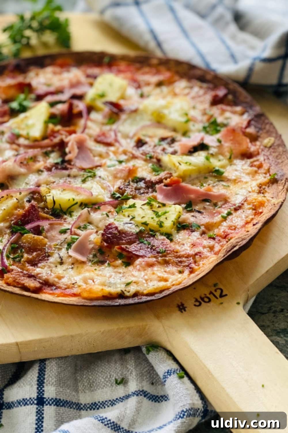 Crispy Aloha Tortilla Pizza 2 A delicious Hawaiian tortilla pizza with ham, bacon, and pineapple, ready to be served.