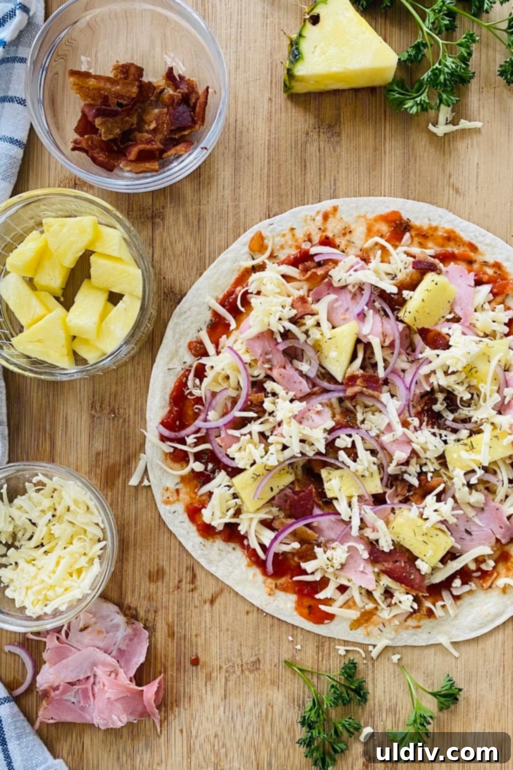 Crispy Aloha Tortilla Pizza 5 Slices of crispy Hawaiian tortilla pizza with ham, bacon, and pineapple.