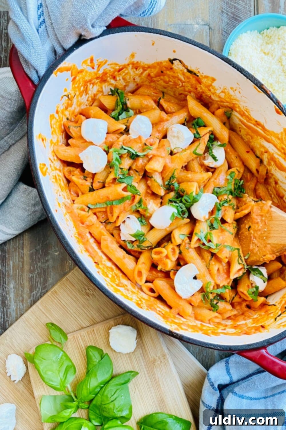 Velvety Tomato Pasta 7 Close-up of creamy tomato pasta noodles with fresh basil and melted mozzarella, highlighting the luxurious texture.