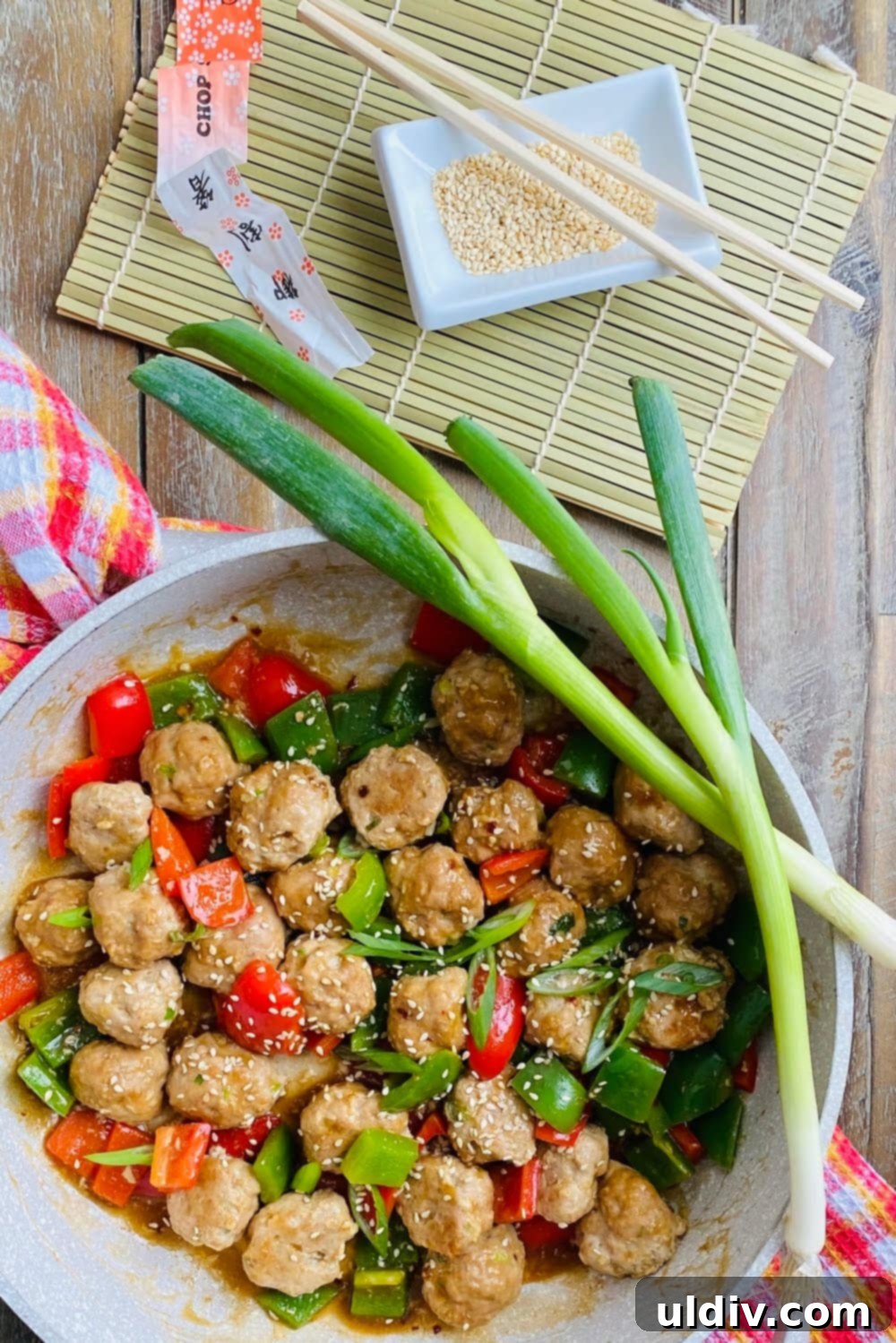 Quick 30-Minute Baked Teriyaki Glazed Turkey Meatballs 3 Close-up of baked teriyaki turkey meatballs simmering in a pan with bell peppers and a glossy sauce.