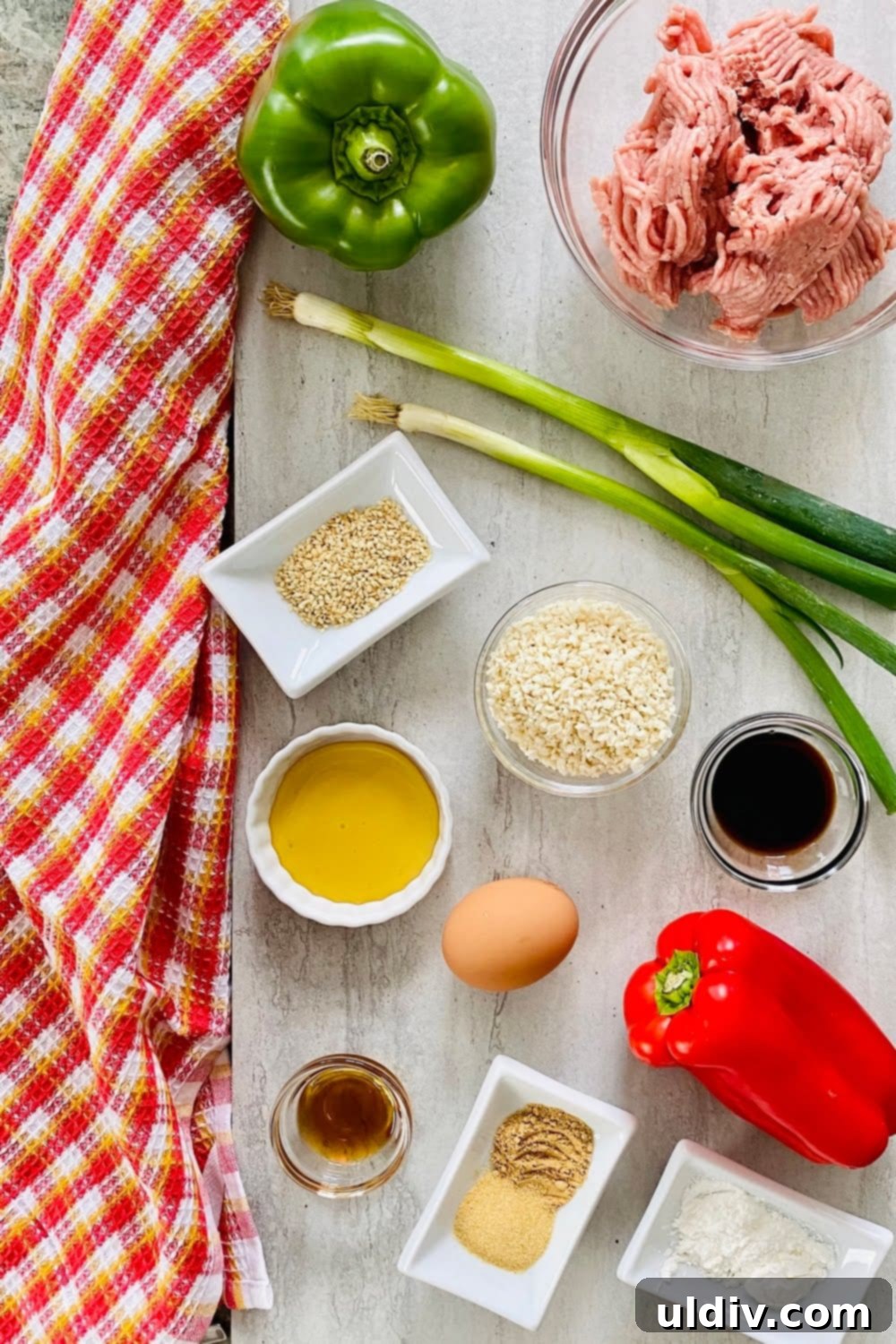 Quick-Baked Teriyaki Turkey Meatballs with a Sticky Glaze 4 Ingredients for teriyaki turkey meatballs laid out: ground turkey, panko breadcrumbs, bell peppers, sesame seeds, and an egg.