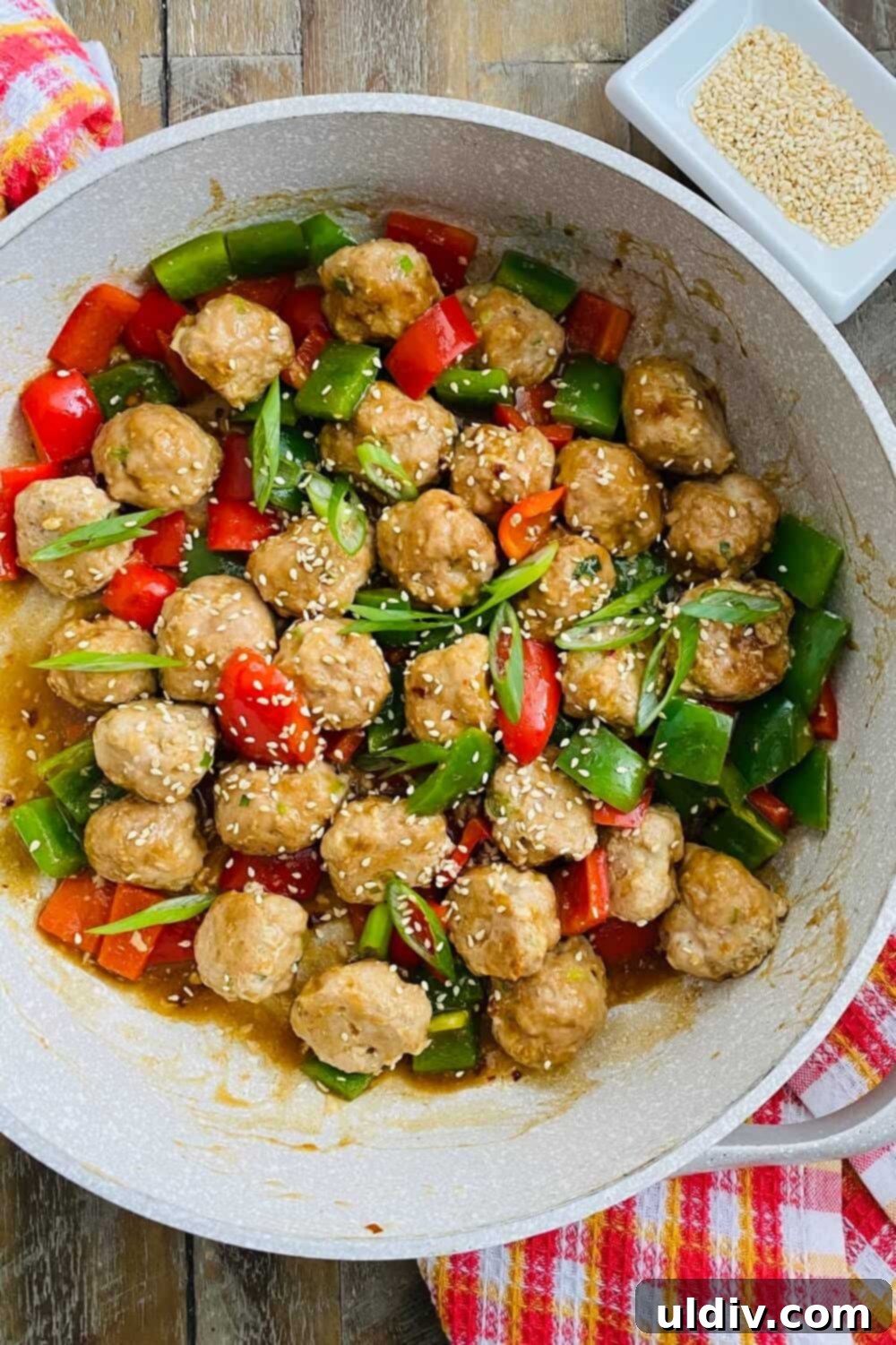 Quick-Baked Teriyaki Turkey Meatballs with a Sticky Glaze 9 Baked teriyaki turkey meatballs and sautéed bell peppers coated in a glossy teriyaki sauce in a pan.