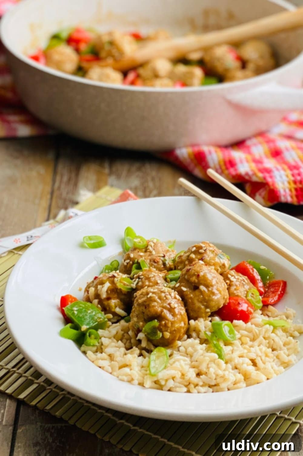 Quick-Baked Teriyaki Turkey Meatballs with a Sticky Glaze 10 A bowl of teriyaki turkey meatballs served with brown rice, garnished with fresh green onions.