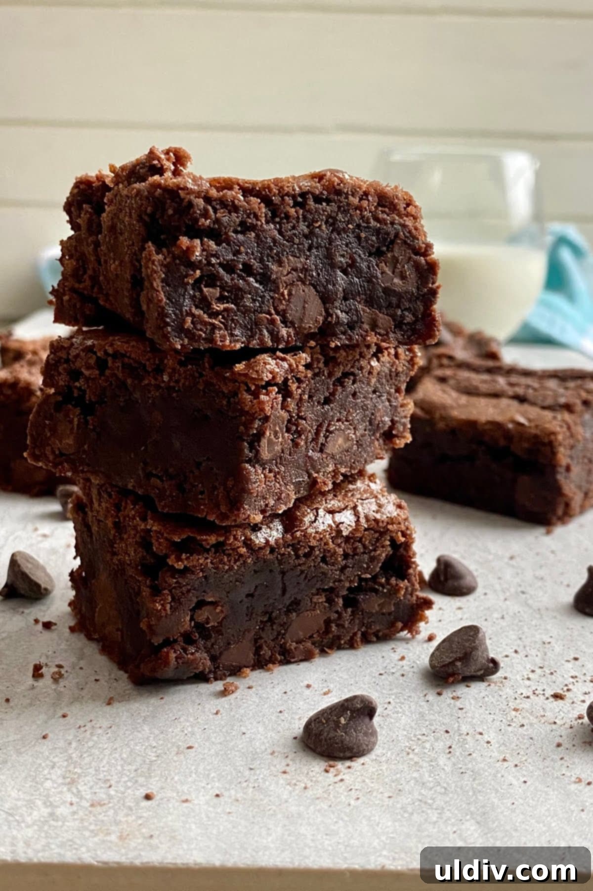 Your New Favorite One Bowl Fudgy Brownies 2 Stack of three incredibly fudgy brownies, showcasing their crinkly tops and dense texture.