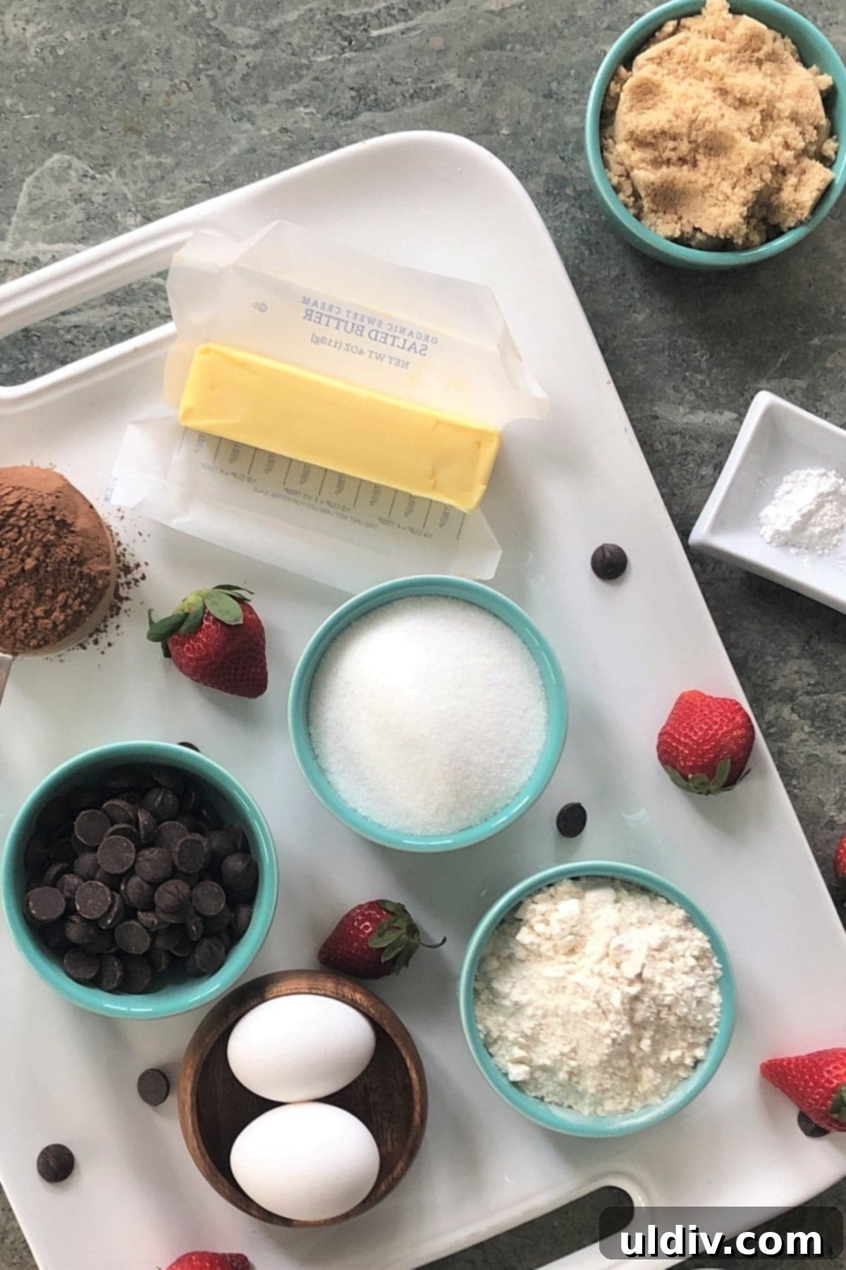 Your New Favorite One Bowl Fudgy Brownies 4 Arrangement of brownie ingredients: butter, chocolate chips, cocoa powder, sugar, flour, brown sugar.