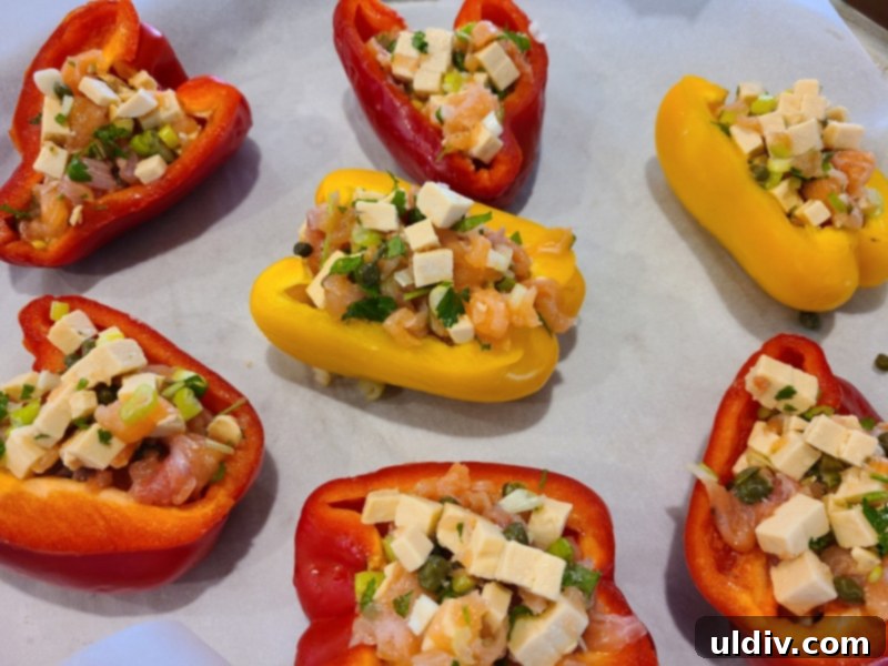 New Year's Kickoff Salmon and Gouda Stuffed Peppers 3 Stuffed bell pepper halves filled with salmon and gouda mixture, ready for the oven