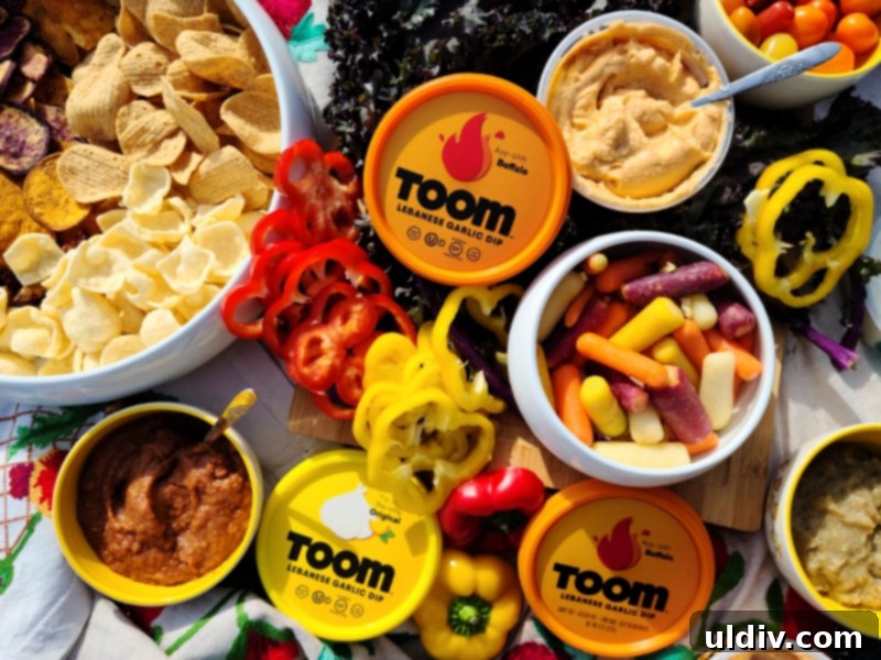Toom: The Super Bowl Foodie Revelation 6 A colorful platter showcasing Toom dips served with a variety of fresh vegetables, crackers, and chips.