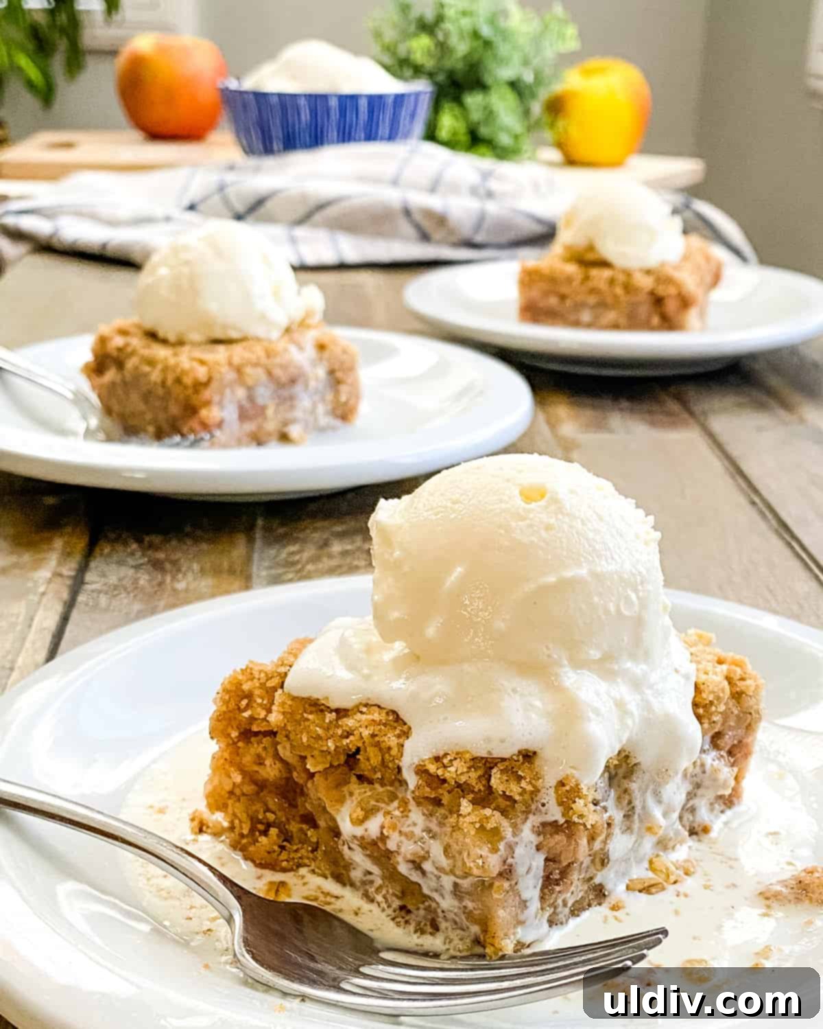 apple crumb bars topped with vanilla ice cream